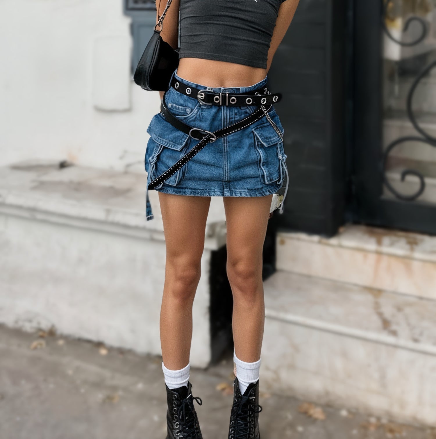 Denim mini skirt with black belt and chain accessory in Y2K Zone collection.