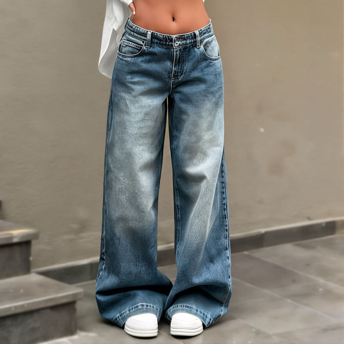 Wide-leg faded blue jeans paired with white sneakers, casual style, Y2K