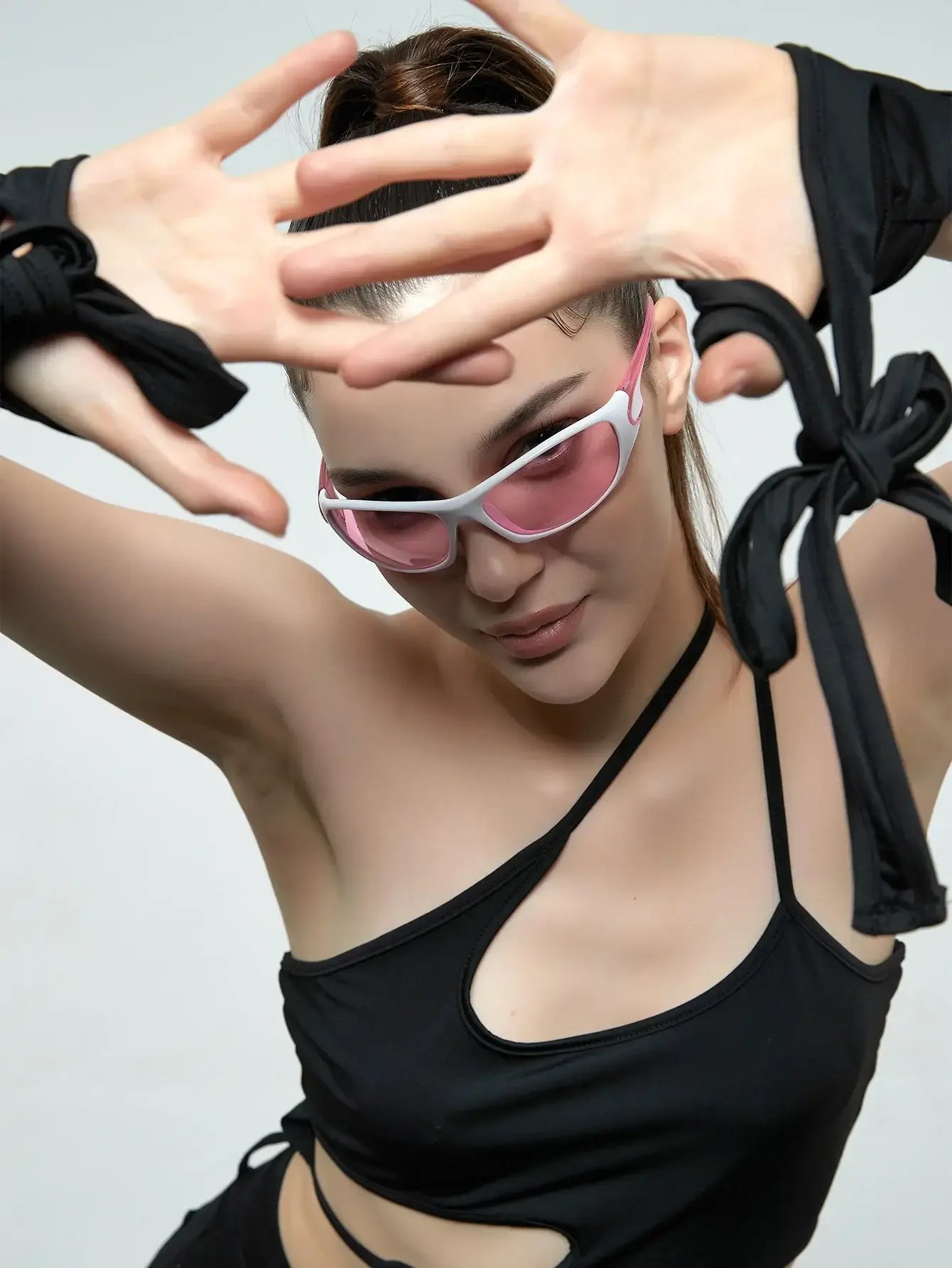 Woman in stylish 2000’s sunglasses and black top, featuring 40mm lens width