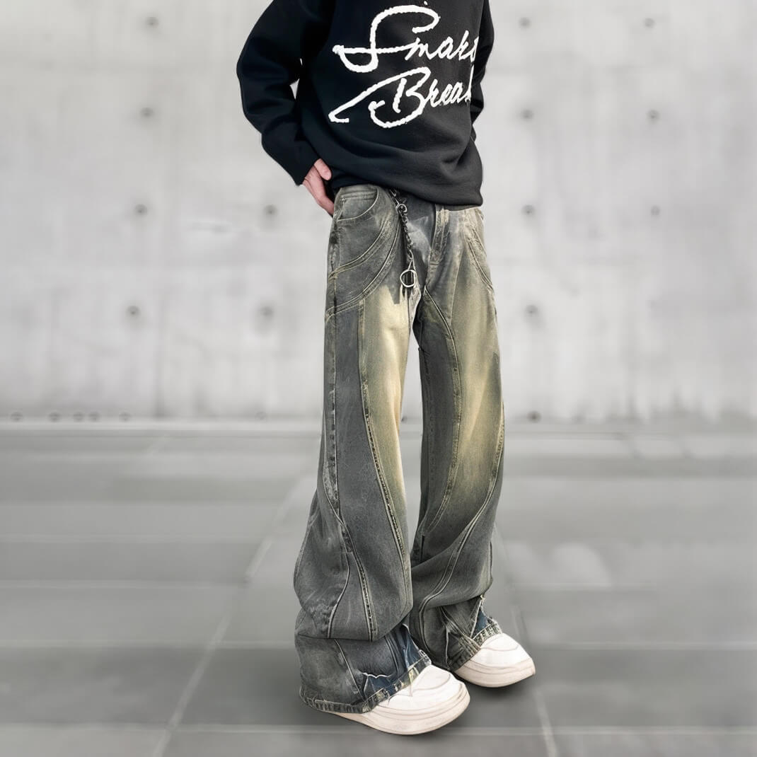 Baggy, washed jeans with chain detail, styled with a black sweatshirt, Y2K