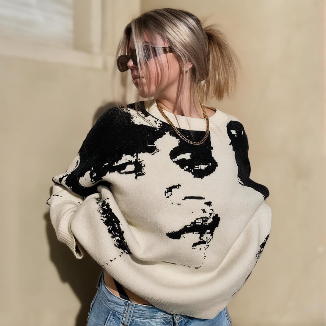 Cream sweater with black graphic print, styled with light denim jeans, Y2K