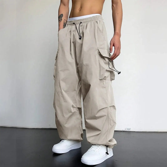 Baggy cargo pants in beige with multiple pockets and a drawstring waist style