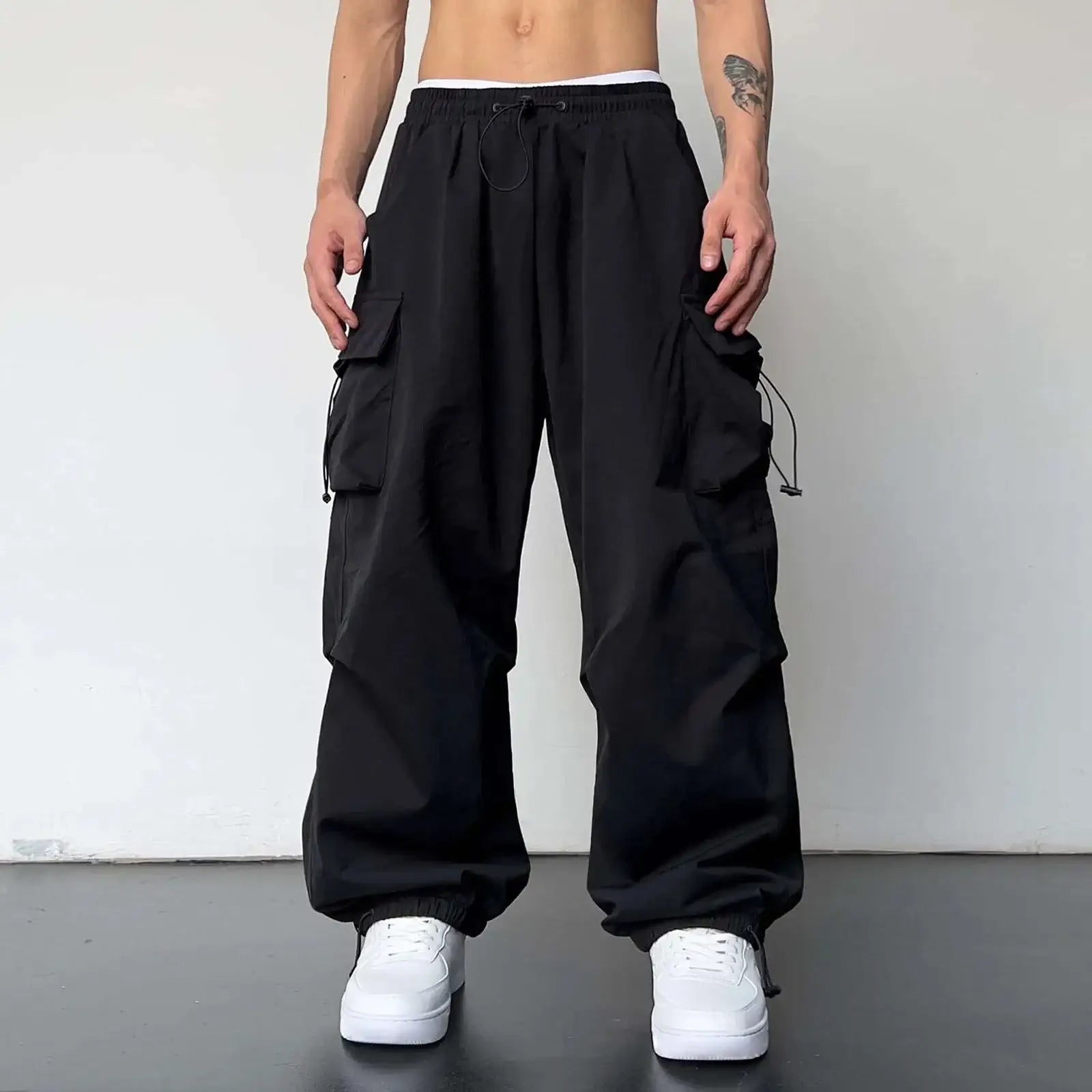 Black baggy cargo pants with drawstring waist and multiple pockets for versatile style