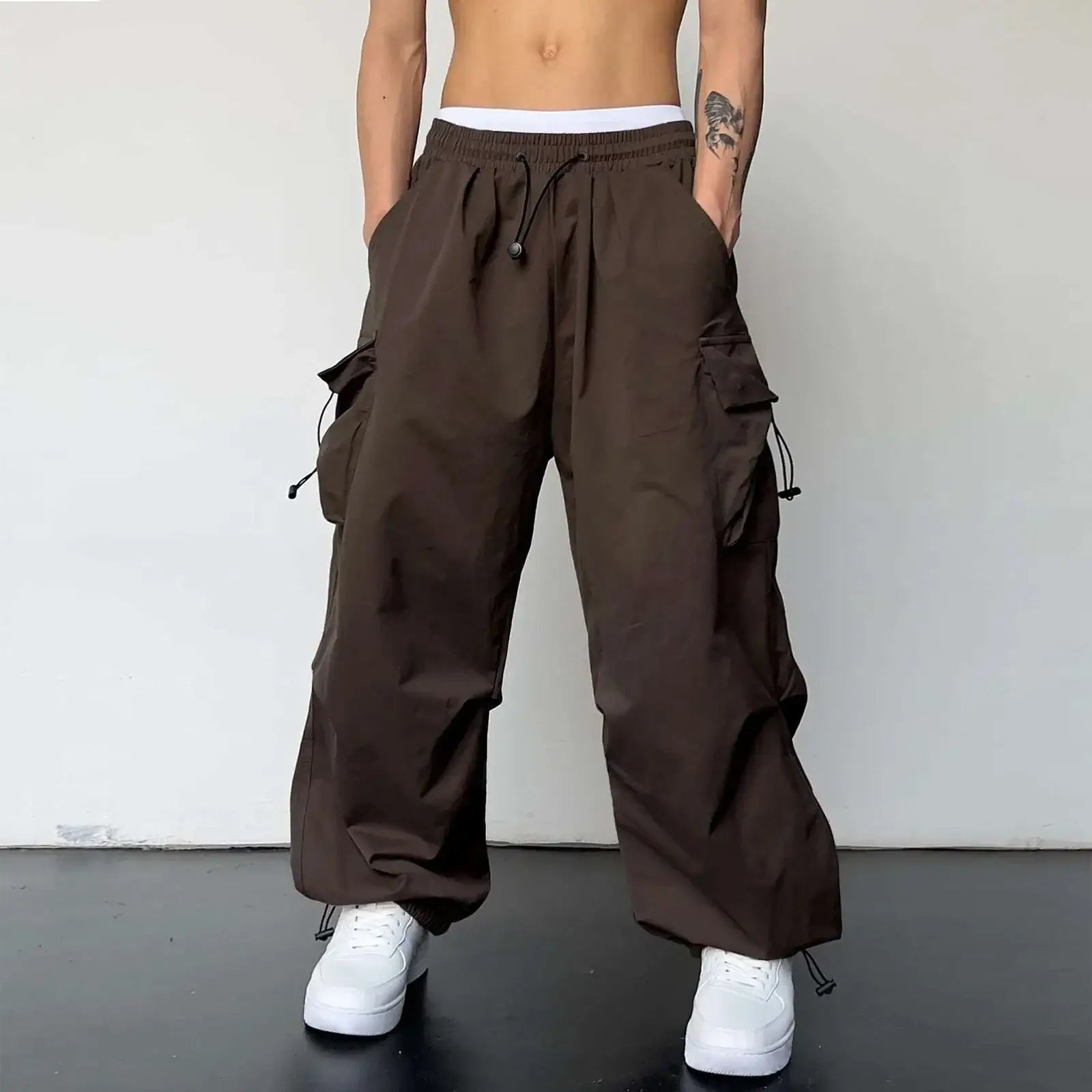 Brown baggy cargo pants featuring wide legs and side pockets for a stylish look