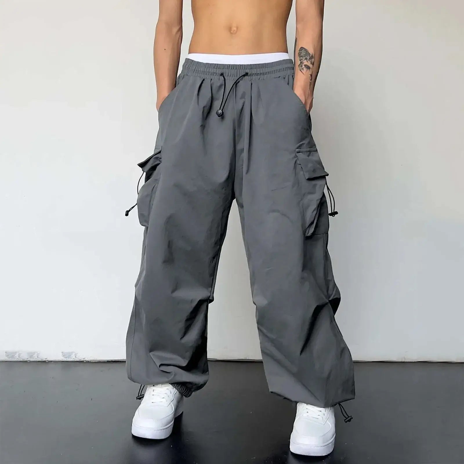 Gray baggy cargo pants with multiple pockets and a drawstring waist for style and utility