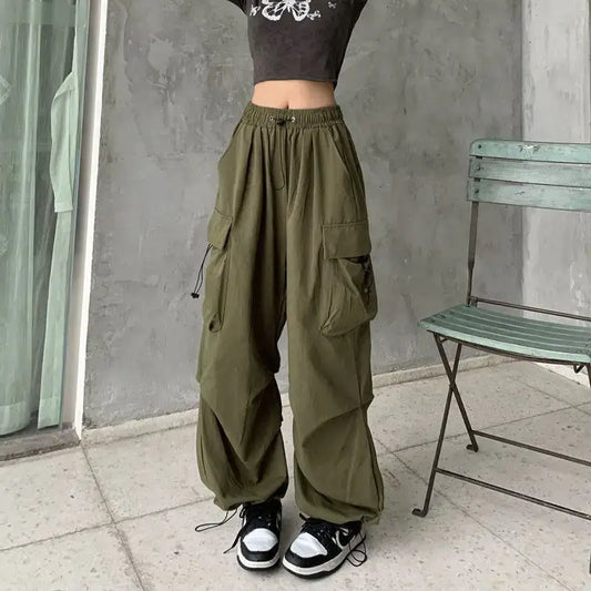 Olive green baggy pants woman featuring multiple large pockets and a loose fit