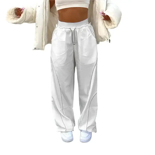 White baggy track pants featuring a relaxed fit and adjustable drawstring for comfort