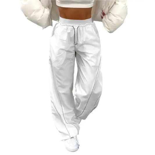 White baggy track pants with drawstring waist and elastic cuffs at the ankles