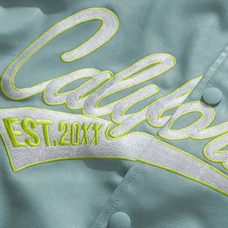 Embroidered Calypso EST 20XX logo on light fabric of a stylish women’s Y2K baseball jacket