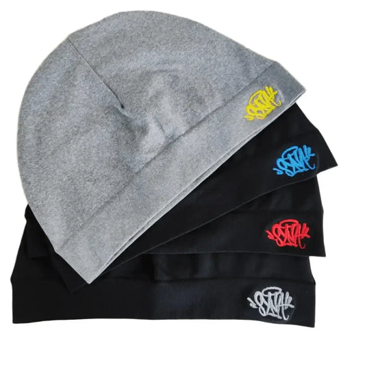 Stack of beanies featuring graffiti-style logos for modern beanie street style