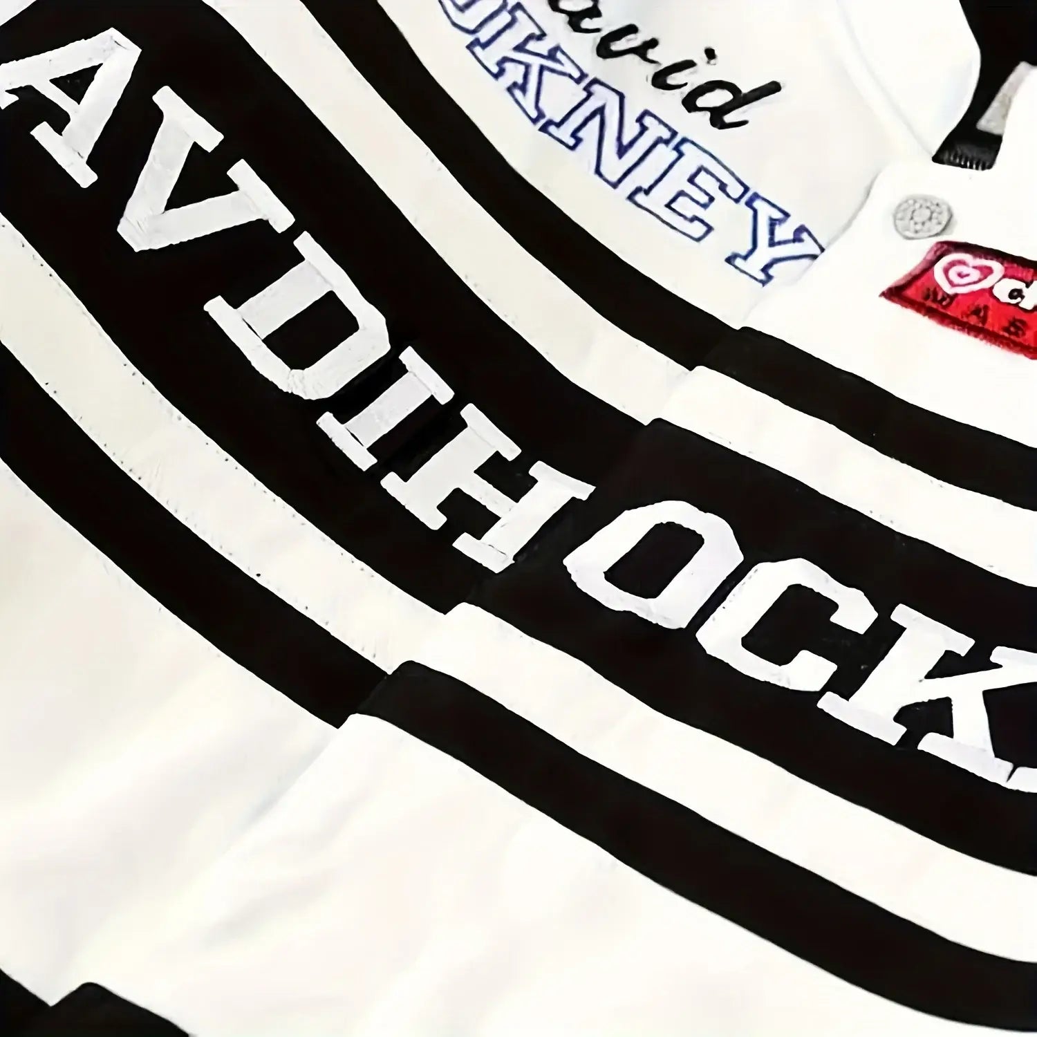 Close-up of black and white striped racing jacket with AVDICOCK text featured