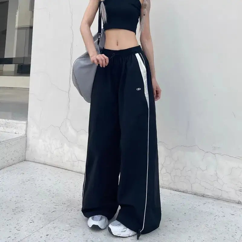 Wide-leg black baggy pants with white side stripes for a stylish look