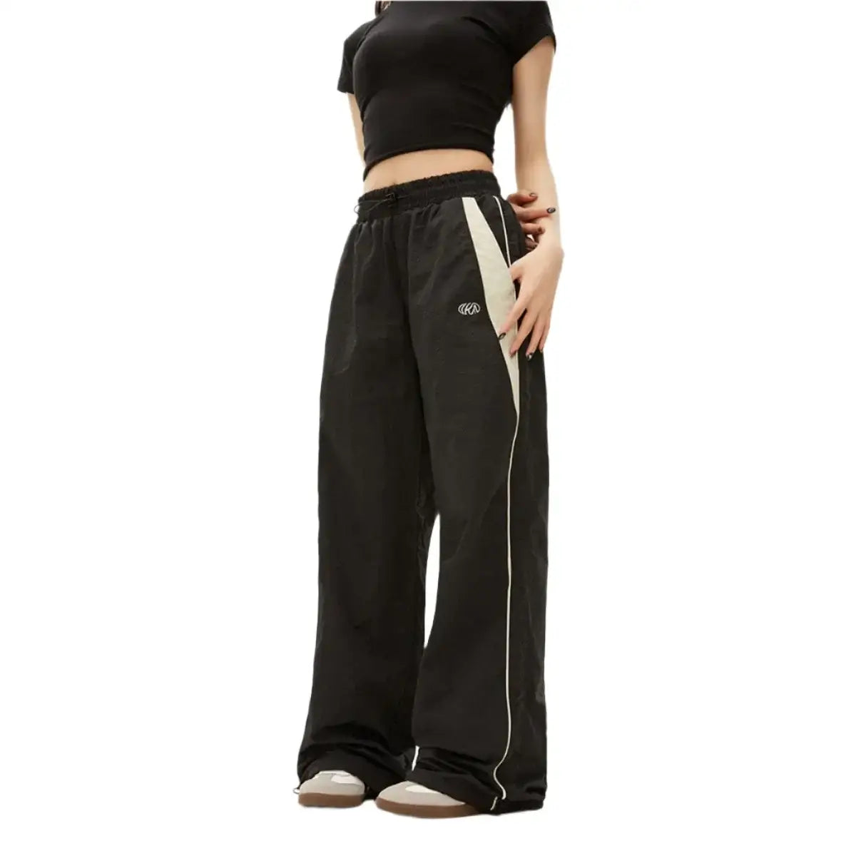 Wide-leg black baggy pants with white side stripes for a stylish athletic look