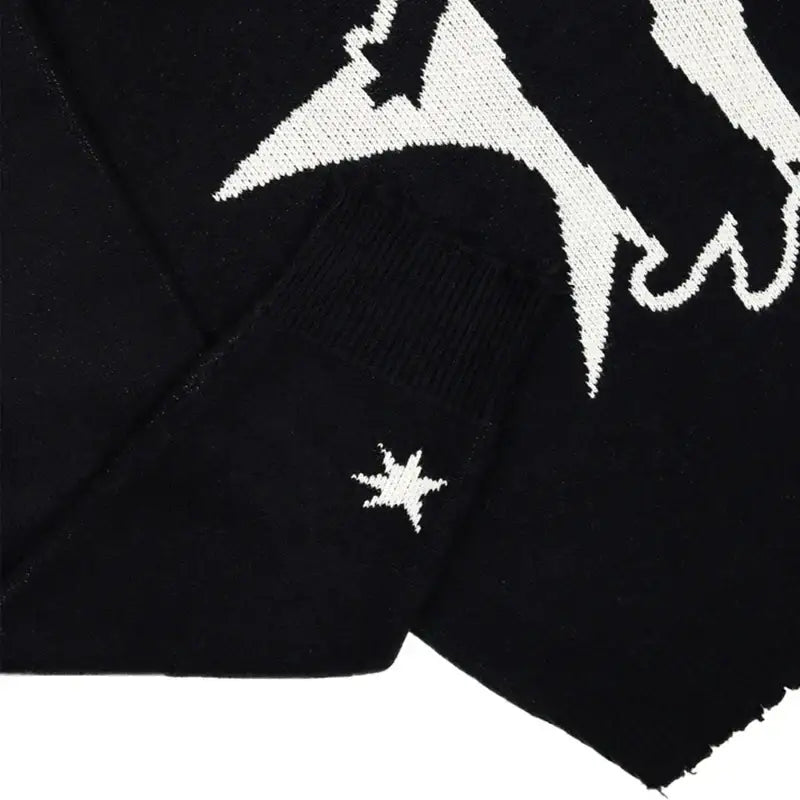 Embroidered white star on black fabric of a stylish Black Knit Sweater