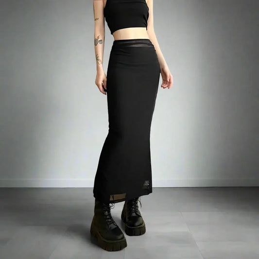 Long black fitted maxi skirt styled with chunky platform boots for a Y2K vibe