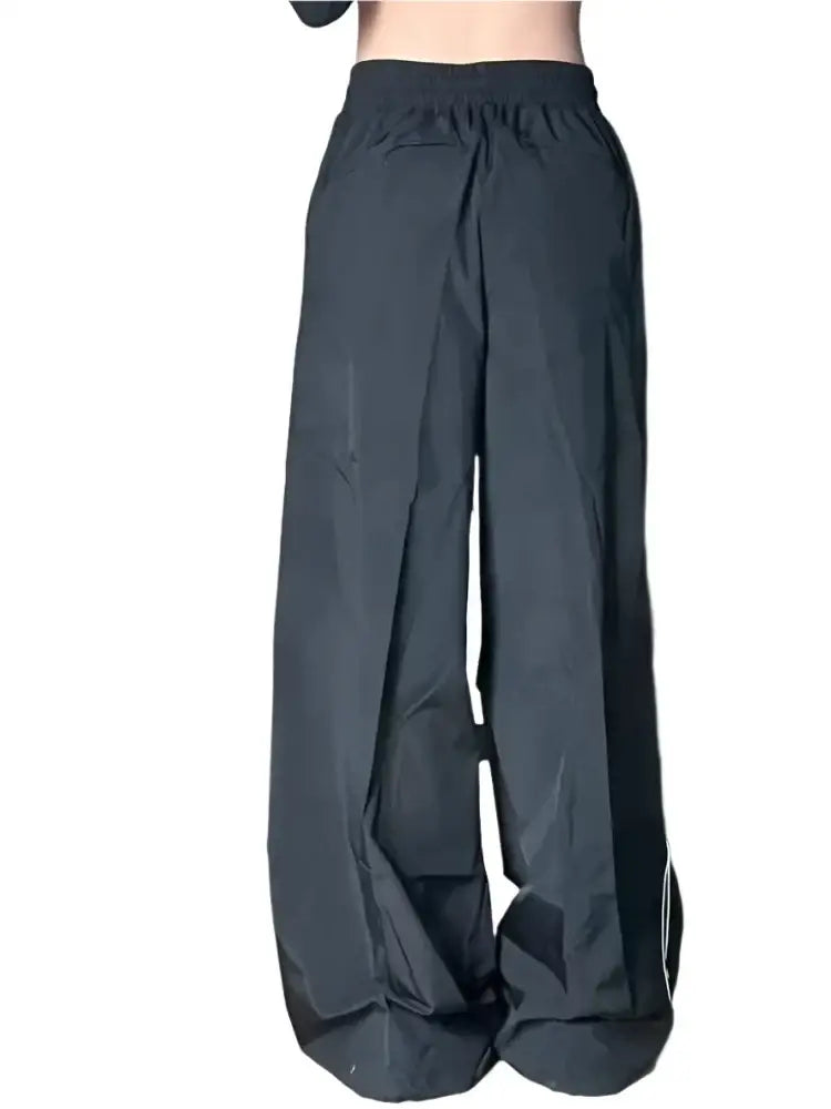 Dark gray wide-leg black parachute pants with an elastic waistband for comfort