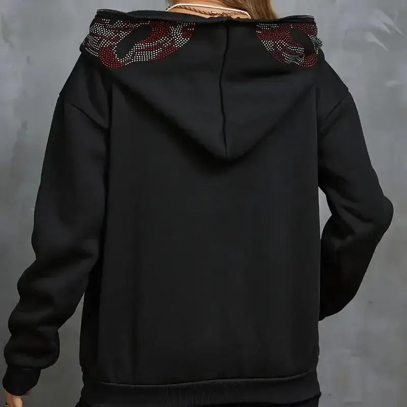 Black rhinestone hoodie featuring decorative embellishments on the hood