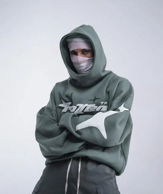 Person in a green Cotton Y2K Hoodie with logo and face covering for stylish comfort