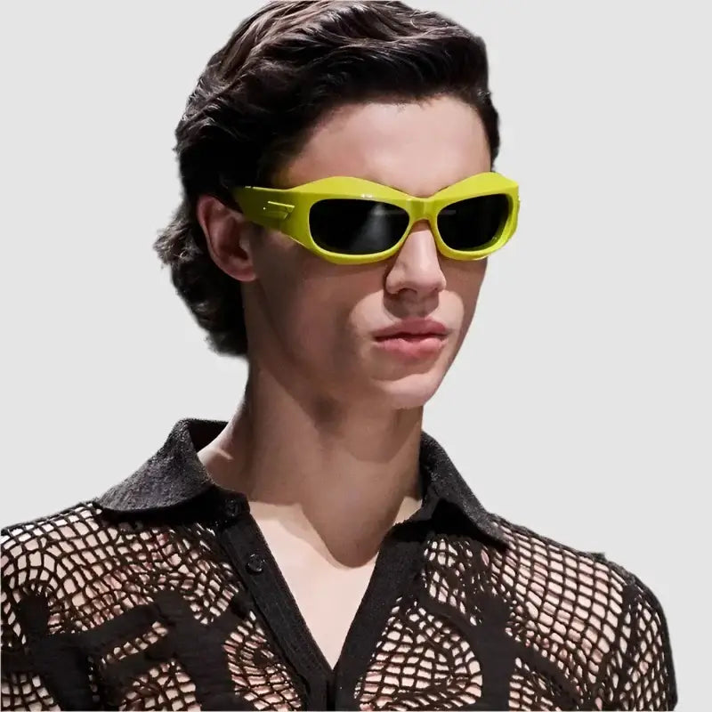 Bright yellow Cyber Y2K sunglasses worn by a person with dark hair