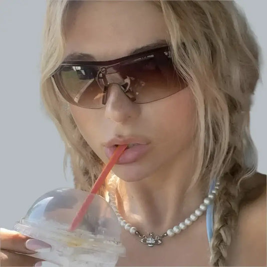 Woman with blonde hair in sunglasses fashion, enjoying a drink wearing stylish cycling sunglasses