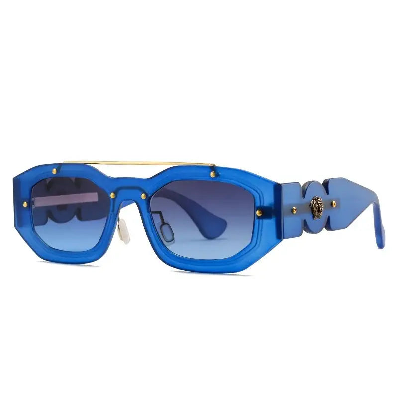 Pair of blue designer sunglasses with gold accents and gradient lenses, perfect y2k style