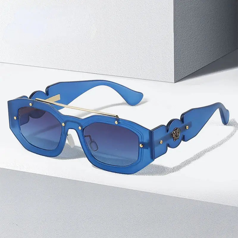 Blue designer sunglasses with gold accents and gradient lenses perfect for Y2K style