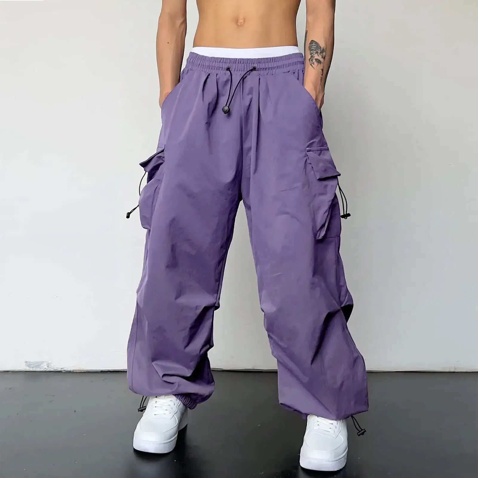 Purple drawstring cargo pants featuring a waist drawstring and side pockets