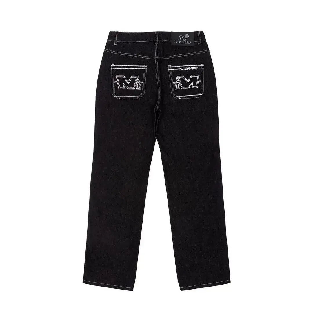 Black denim Drip Jeans featuring unique ’M’ logo pockets, perfect Y2K fashion