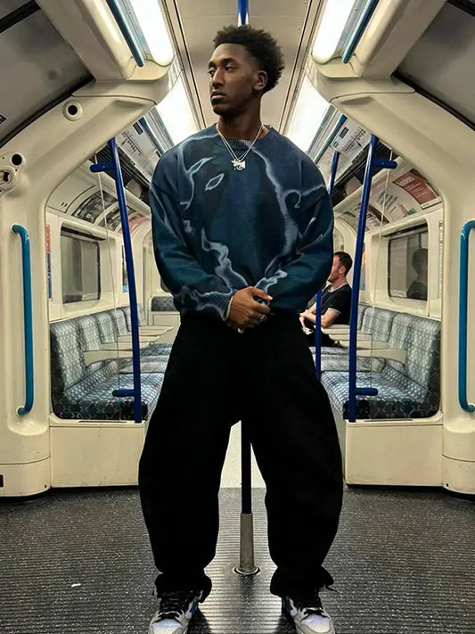 Young man in blue drip sweater and black pants inside a subway car, Y2K style