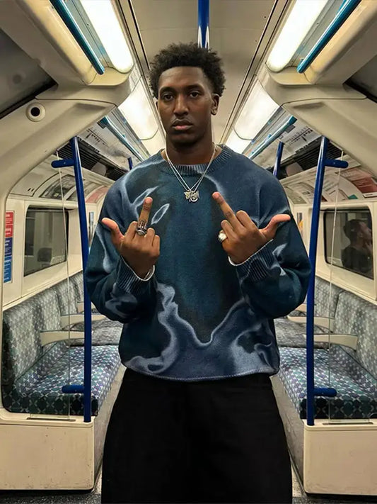 Person in a blue Drip Sweater gesturing on a subway, showcasing Y2K style