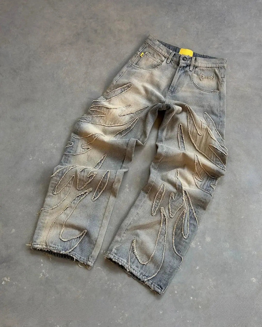 Distressed gray Fire Jeans with rips and paint splatters in a stylish Y2K wide leg fit