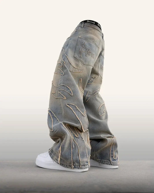 Baggy Fire Jeans with embroidered designs paired with white sneakers, a stylish y2k look