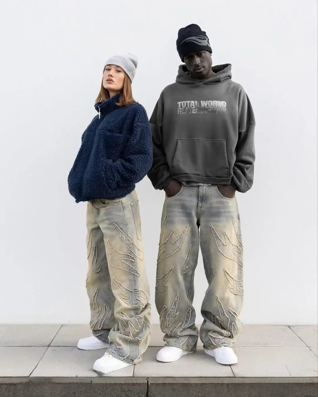 Two people in oversized baggy clothing and sneakers wearing Y2K wide leg Fire Jeans