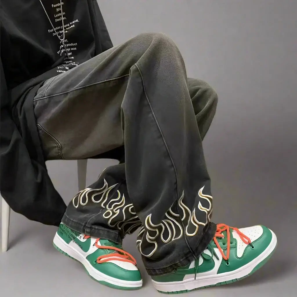 Pair of green and white sneakers with flame designs on Flame Jeans in loose fit style