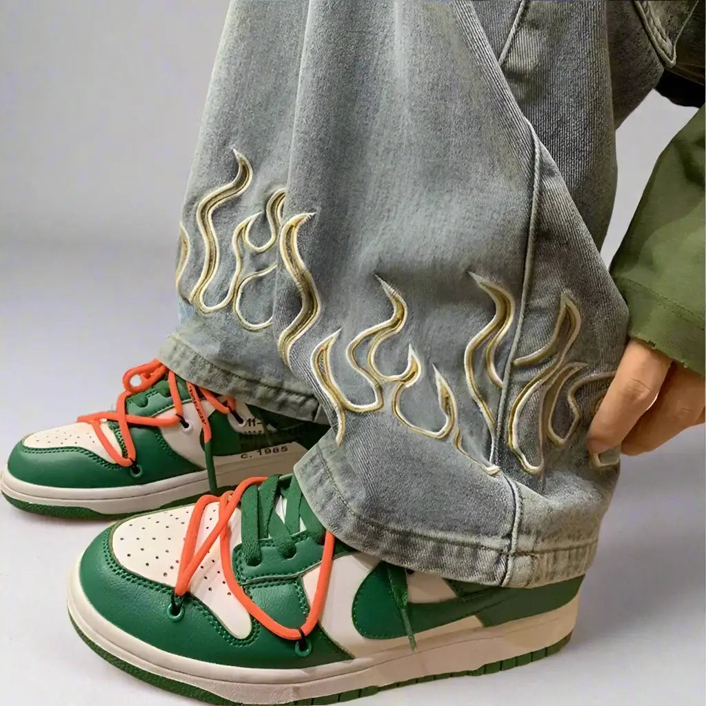 Green and white sneakers with orange laces paired with Y2K flame jeans in loose fit