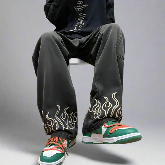 Pair of loose fit Flame Jeans with flame designs, styled with green and orange sneakers