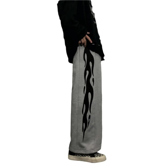 Light-colored Flame Pants featuring a bold black flame design on the side