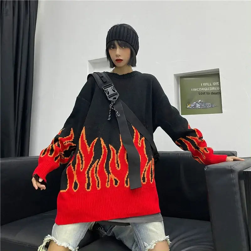 Black vintage flame printed sweater featuring a bold red flame design on the bottom