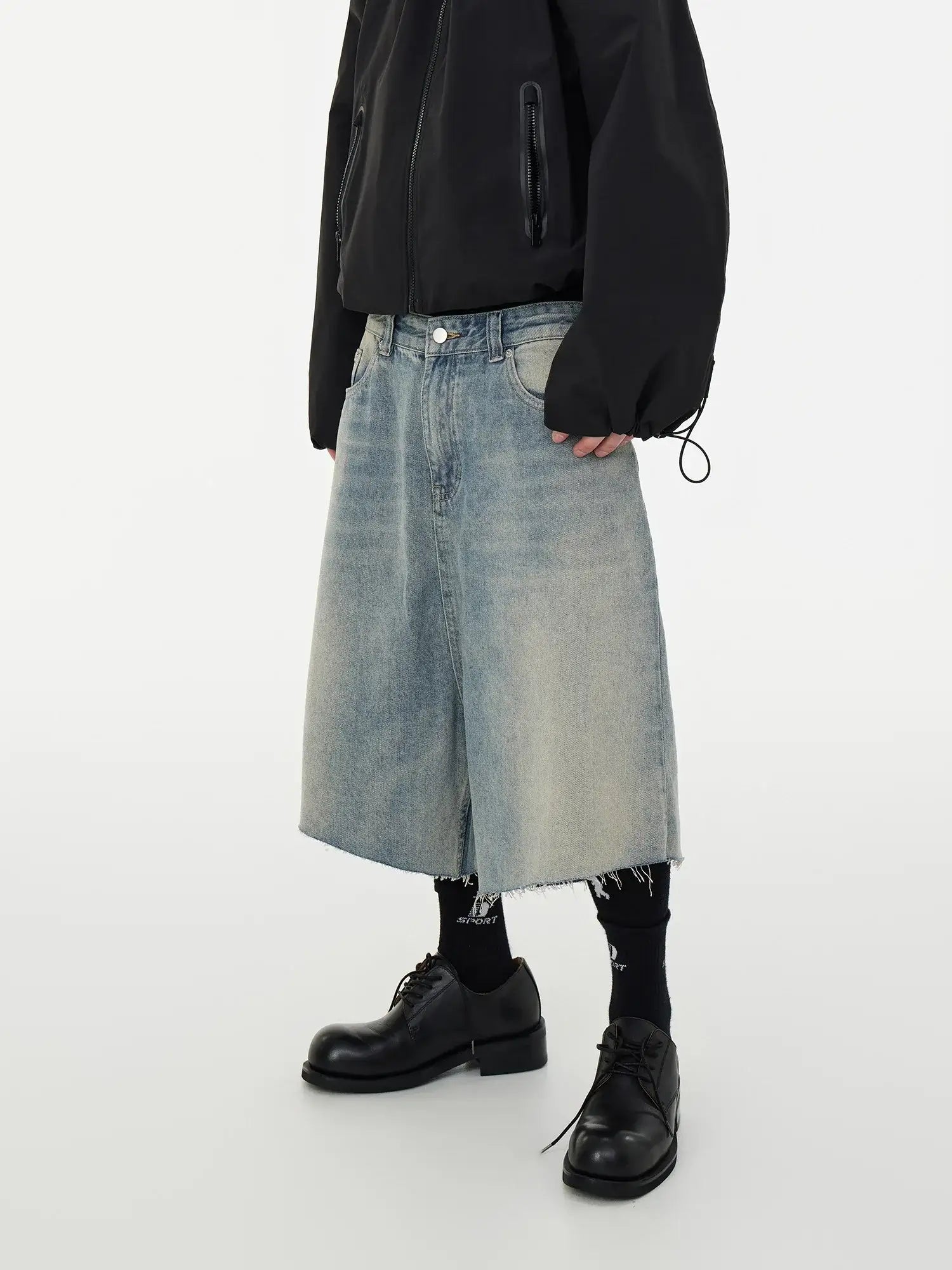 Long denim skirt with frayed hem over black tights and chunky boots, styled for frayed hem shorts