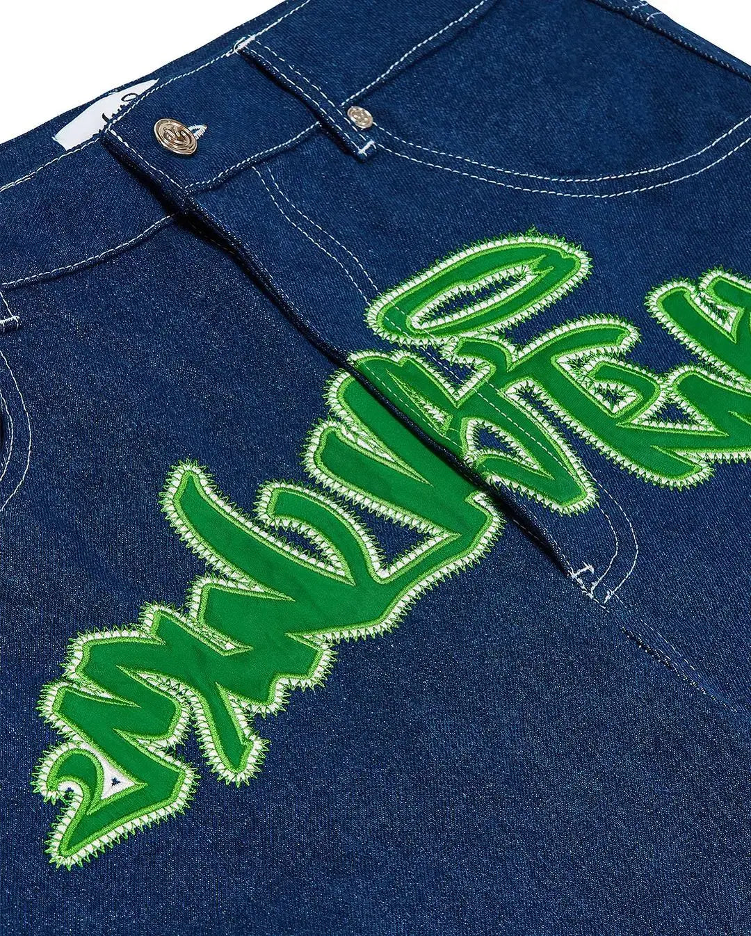 Denim jeans featuring bright green graffiti-style text, perfect for Y2K clothing men