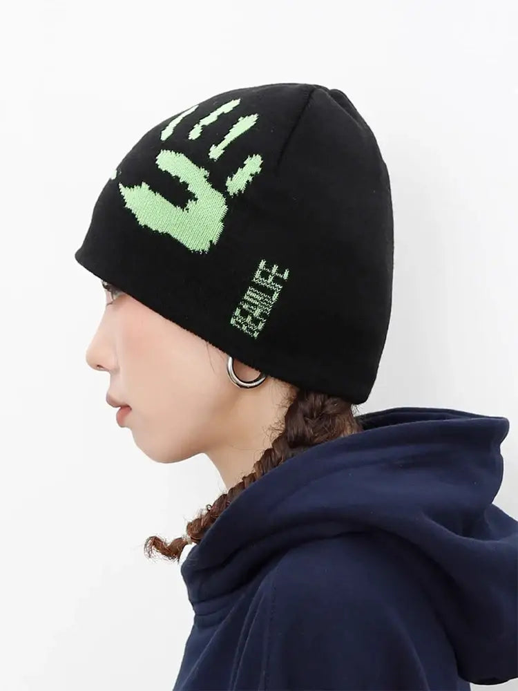 Black knit graphic beanie featuring a green handprint design to stay warm