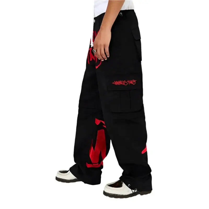 Black baggy graphic pants with red flame designs, perfect for women’s Y2K clothing