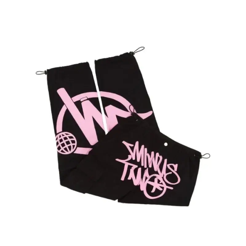 Black golf towel with pink logo complements Graphic Pants in stylish Y2K women’s fashion