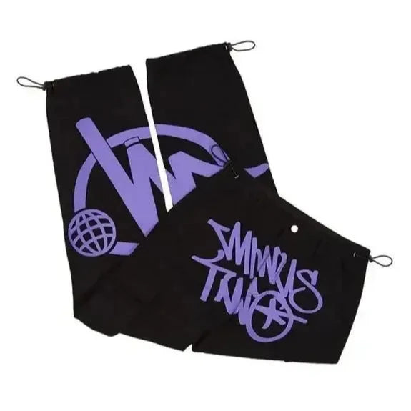 Black golf towel featuring purple Minnkota Turf logo, perfect for graphic pants ensemble