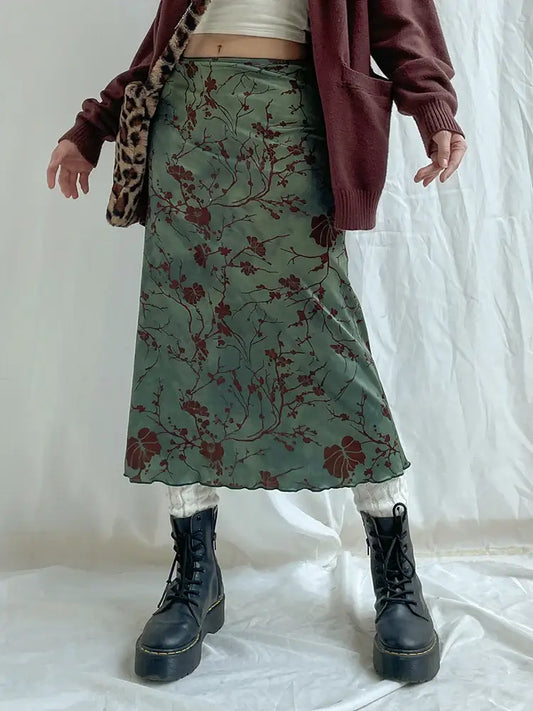 Floral midi skirt in green paired with black combat boots and a burgundy cardigan