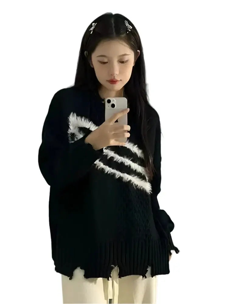 Woman in black and white trendy Harajuku sweater taking a selfie with a smartphone