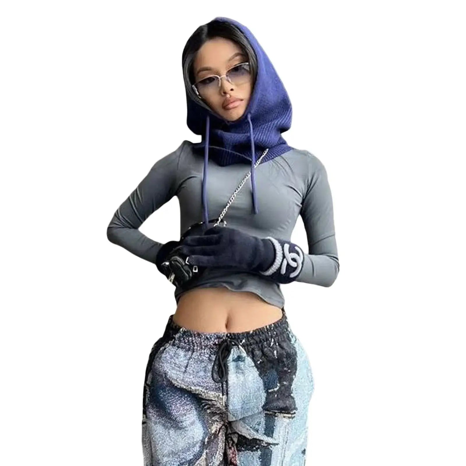 Woman in blue hooded top and patterned pants showcasing a stylish head scarf