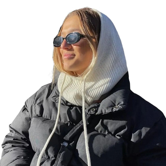 Person in a puffy black jacket and sunglasses wearing a stylish head scarf