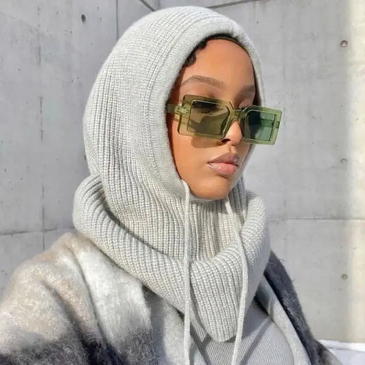 Woman in white knit hijab and green sunglasses showcasing a stylish head scarf