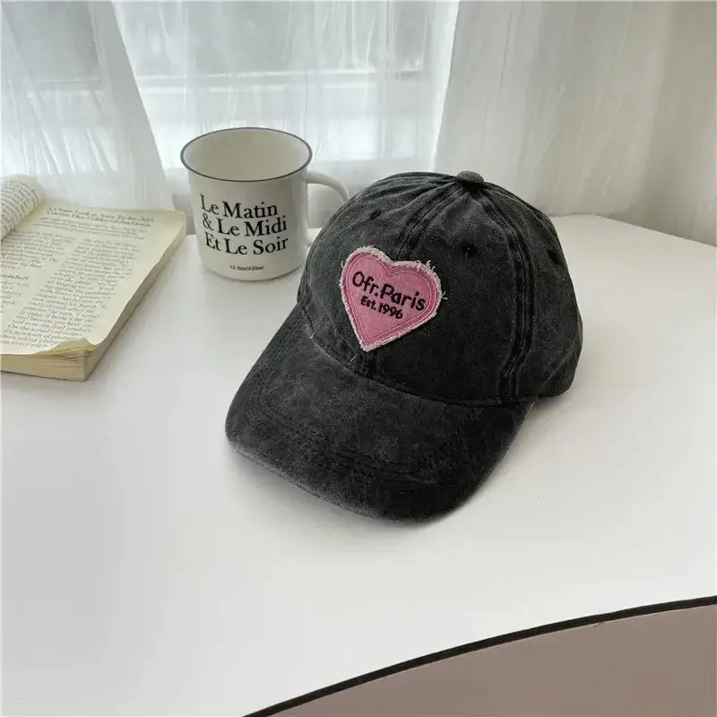 Black Heart Cap featuring a stylish pink heart-shaped patch, perfect Y2K accessory